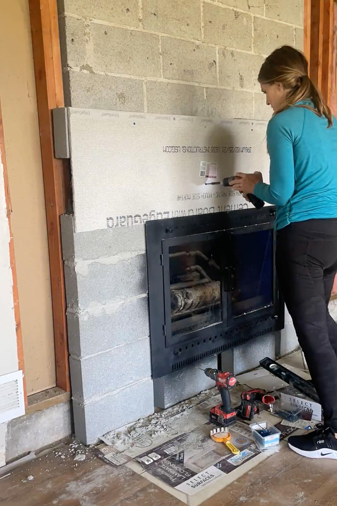 Adding cement board to my fireplace surround.